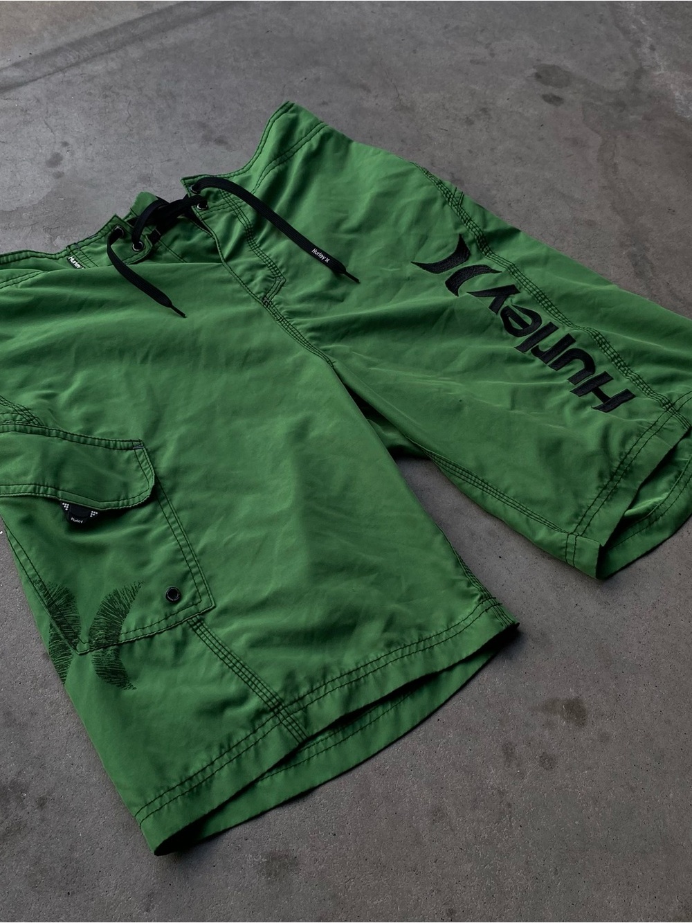 Baggy vintage Hurley green board shorts with embroidery on legs